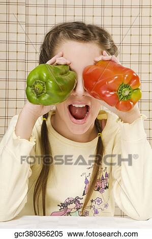 Close-up of a girl holding bell peppers over her eyes View Large Photo Image Stock Photography - Close-up of a girl holding bell peppers over her eyes. Fotosearch