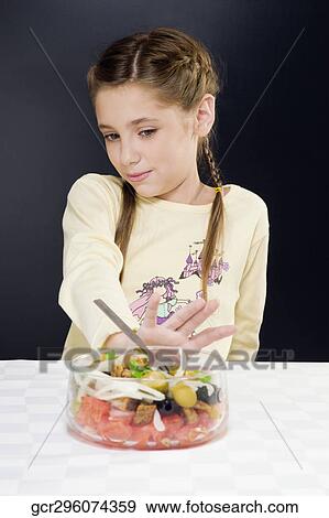 Close-up of a girl pushing a bowl of salad away View Large Photo Image Stock Photo - Close-up of a girl pushing a bowl of salad away. Fotosearch