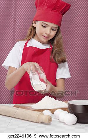 Close-up of a girl putting flour on a chopping board View Large Photo Image Stock Photo - Close-up of a girl putting flour on a chopping board. Fotosearch