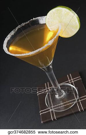 Close-up of a glass of cocktail with lime slice View Large Photo Image Stock Photography - Close-up of a glass of cocktail with lime slice. Fotosearch