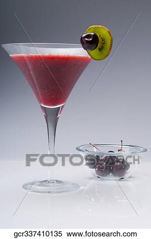 Stock Photography - Close-up of a glass of kiwi and cherry cocktail. Fotosearch