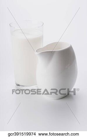Close-up of a glass of milk and a white ceramic jug View Large Photo Image Picture - Close-up of a glass of milk and a white ceramic jug. Fotosearch