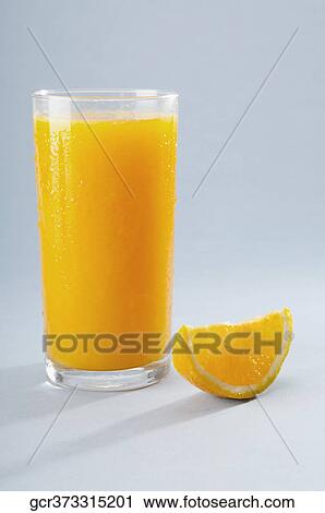 Close-up of a glass of orange juice with a slice of orange View Large Photo Image Stock Image - Close-up of a glass of orange juice with a slice of orange. Fotosearch