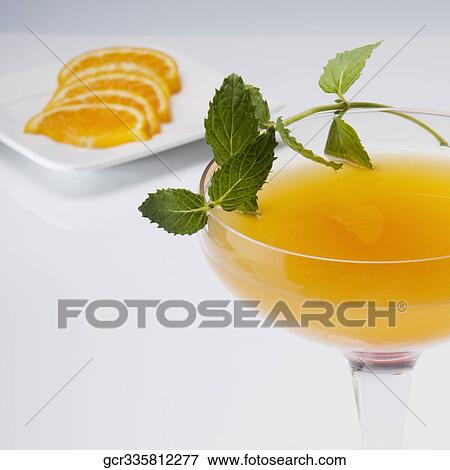 Stock Photo - Close-up of a glass of orange juice with orange slices. Fotosearch