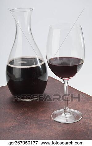 Close-up of a glass of red wine with a pitcher View Large Photo Image Stock Photo - Close-up of a glass of red wine with a pitcher. Fotosearch