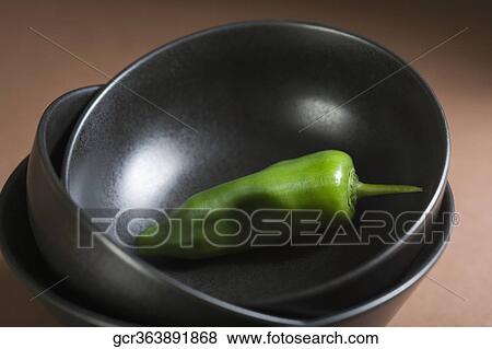 Close-up of a green chili pepper in a bowl View Large Photo Image Stock Photo - Close-up of a green chili pepper in a bowl. Fotosearch