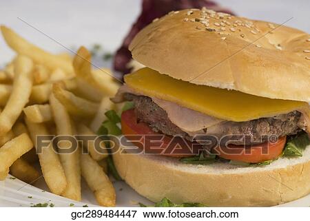Stock Photo - Close-up of a hamburger and french fries. Fotosearch