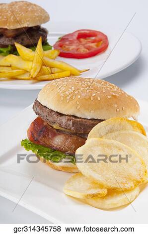 Close-up of a hamburger with chips View Large Photo Image Stock Photo - Close-up of a hamburger with chips. Fotosearch