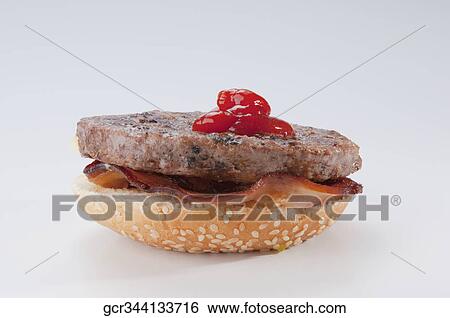 Close-up of a hamburger with tomato sauce View Large Photo Image Stock Photograph - Close-up of a hamburger with tomato sauce. Fotosearch