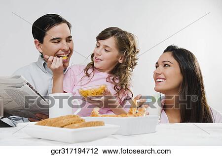 Close-up of a happy family eating breakfast View Large Photo Image Stock Image - Close-up of a happy family eating breakfast. Fotosearch