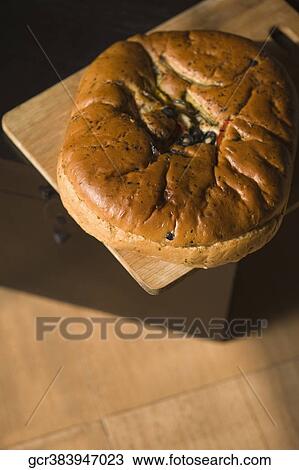 Close-up of a loaf of bread on a cutting board View Large Photo Image Stock Image - Close-up of a loaf of bread on a cutting board. Fotosearch