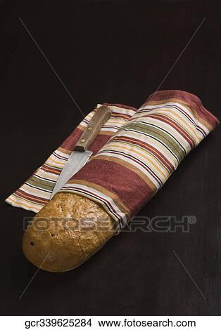 Close-up of a loaf of bread with a knife View Large Photo Image Picture - Close-up of a loaf of bread with a knife. Fotosearch