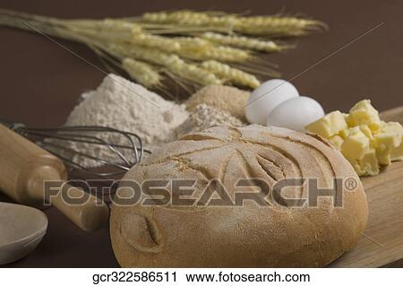 Close-up of a loaf of bread with eggs on a cutting board View Large Photo Image Stock Image - Close-up of a loaf of bread with eggs on a cutting board. Fotosearch