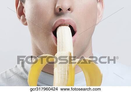 Close-up of a man eating a banana View Large Photo Image Picture - Close-up of a man eating a banana. Fotosearch