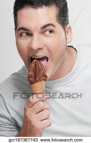 Close-up of a man eating an ice cream cone View Large Photo Image Stock Image - Close-up of a man eating an ice cream cone. Fotosearch