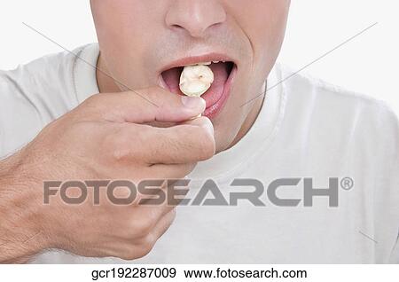 Stock Photo - Close-up of a man eating an ice cream. Fotosearch