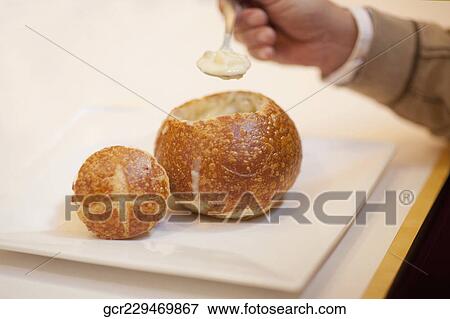 Close-up of a man eating soup from a bread bowl View Large Photo Image Stock Photo - Close-up of a man eating soup from a bread bowl. Fotosearch