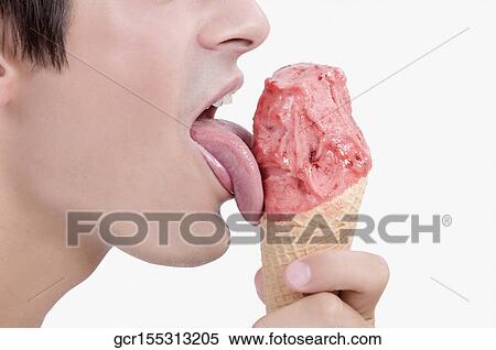 Close-up of a man licking an ice cream View Large Photo Image Stock Photography - Close-up of a man licking an ice cream. Fotosearch