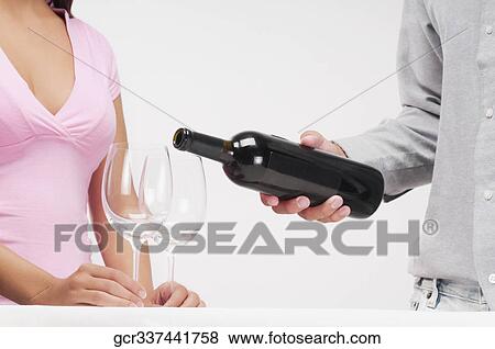 Close-up of a man pouring wine in wine glasses View Large Photo Image Stock Photo - Close-up of a man pouring wine in wine glasses. Fotosearch
