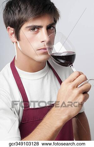 Close-up of a man smelling a glass of red wine View Large Photo Image Stock Photo - Close-up of a man smelling a glass of red wine. Fotosearch