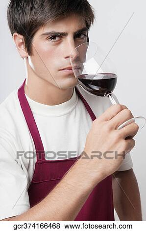 Close-up of a man smelling a glass of red wine View Large Photo Image Stock Photo - Close-up of a man smelling a glass of red wine. Fotosearch