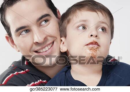 Close-up of a man with his son View Large Photo Image Stock Photo - Close-up of a man with his son. Fotosearch