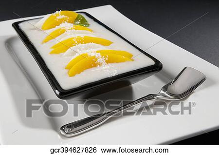 Stock Photograph - Close-up of a mango and coconut dessert. Fotosearch