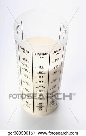 Close-up of a measuring glass filled with milk View Large Photo Image Stock Photo - Close-up of a measuring glass filled with milk. Fotosearch