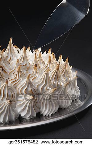 Stock Image - Close-up of a meringue pie with a cake server. Fotosearch