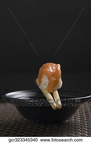 Close-up of a Nigiri Sushi with chopsticks on a bowl View Large Photo Image Stock Image - Close-up of a Nigiri Sushi with chopsticks on a bowl. Fotosearch