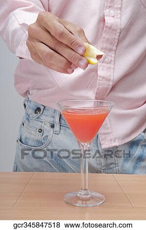 Close-up of a person with a martini glass View Large Photo Image Stock Photo - Close-up of a person with a martini glass. Fotosearch