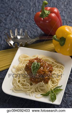 Stock Image - Close-up of a plate of cooked pasta with bell peppers. Fotosearch