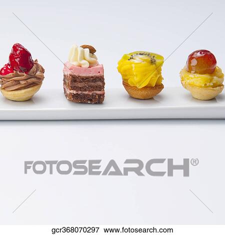 Stock Photo - Close-up of a platter of assorted tarts and pastries. Fotosearch