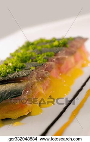 Close-up of a platter of fish garnished with leeks View Large Photo Image Picture - Close-up of a platter of fish garnished with leeks. Fotosearch