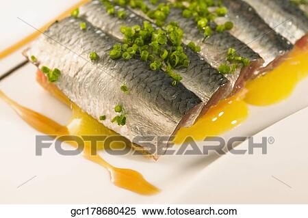 Close-up of a platter of fish garnished with leeks View Large Photo Image Stock Photography - Close-up of a platter of fish garnished with leeks. Fotosearch