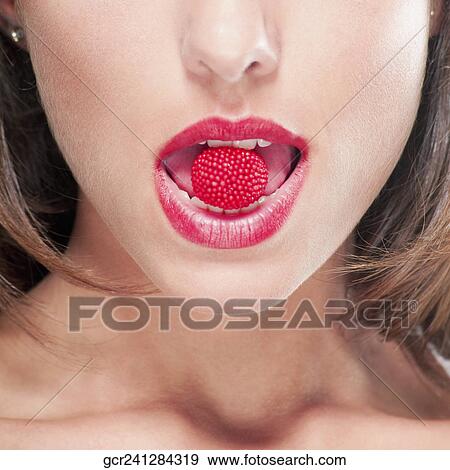 Close-up of a raspberry in a woman's mouth View Large Photo Image Stock Photo - Close-up of a raspberry in a woman's mouth. Fotosearch