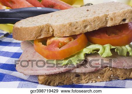 Close-up of a salami sandwich with lettuce and tomatoes View Large Photo Image Stock Photo - Close-up of a salami sandwich with lettuce and tomatoes. Fotosearch