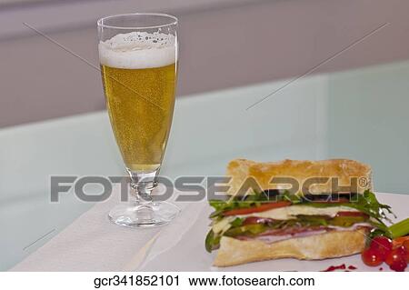 Close-up of a sandwich with a glass of beer View Large Photo Image Stock Image - Close-up of a sandwich with a glass of beer. Fotosearch