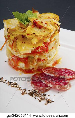 Picture - Close-up of a slice of lasagne with salami. Fotosearch