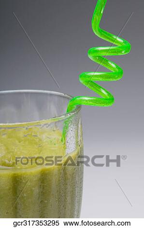 Stock Photography - Close-up of a spiral straw in kiwi fruit cocktail. Fotosearch