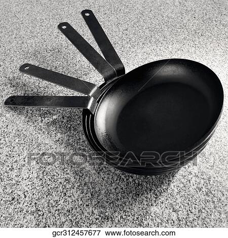 Close-up of a stack of frying pans View Large Photo Image Stock Photo - Close-up of a stack of frying pans. Fotosearch