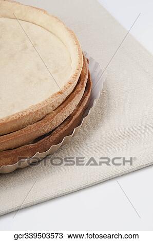 Stock Image - Close-up of a stack of tart bases. Fotosearch