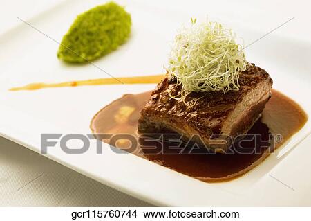 Picture - Close-up of a steak served with sauce. Fotosearch