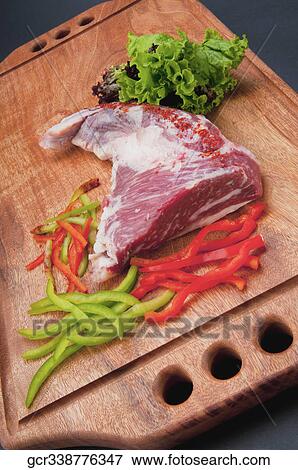 Stock Photo - Close-up of a steak with ground red chillies and peppers. Fotosearch