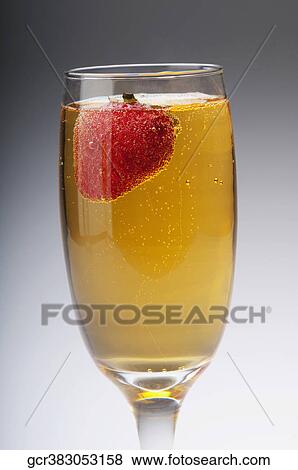 Stock Photo - Close-up of a strawberry in a champagne flute. Fotosearch