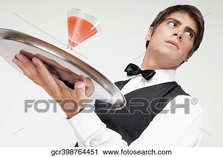 Close-up of a waiter holding a cocktail on a tray View Large Photo Image Stock Image - Close-up of a waiter holding a cocktail on a tray. Fotosearch