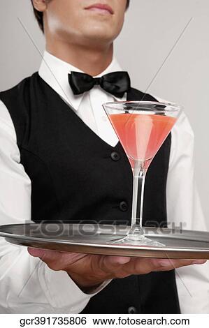Close-up of a waiter holding a cocktail on a tray View Large Photo Image Stock Photograph - Close-up of a waiter holding a cocktail on a tray. Fotosearch