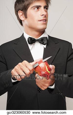 Close-up of a waiter peeling an apple View Large Photo Image Stock Image - Close-up of a waiter peeling an apple. Fotosearch
