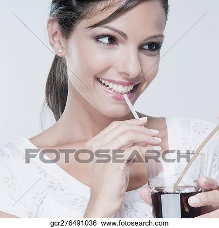 Close-up of a woman drinking a cola beverage View Large Photo Image Stock Photograph - Close-up of a woman drinking a cola beverage. Fotosearch