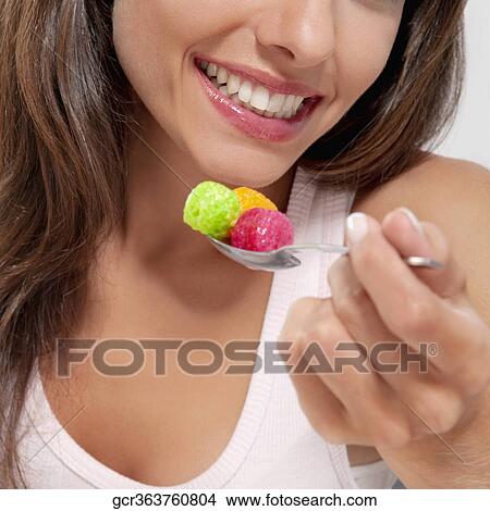 Picture - Close-up of a woman eating cereal. Fotosearch